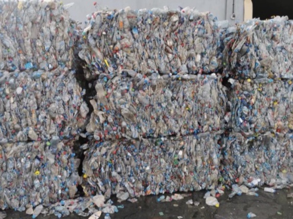 Compressed post-consumer bottle bales awaiting processing