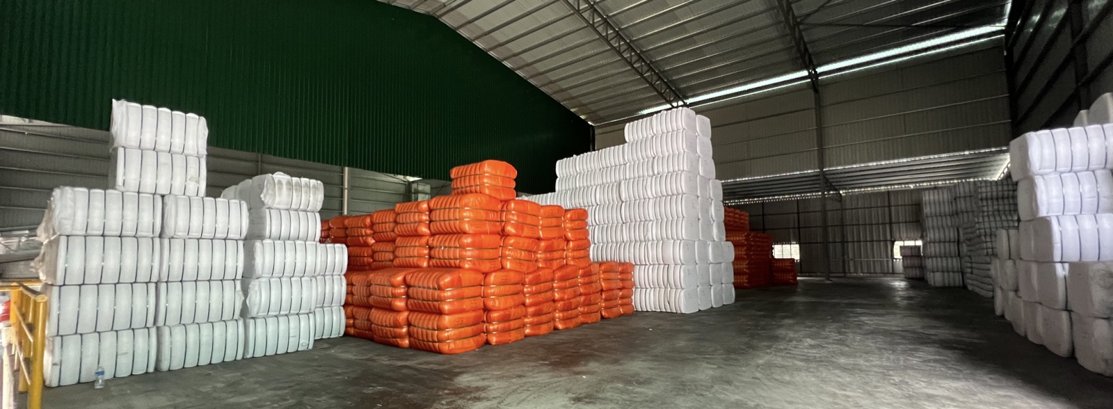 Warehouse stacked with baled recycled fiber